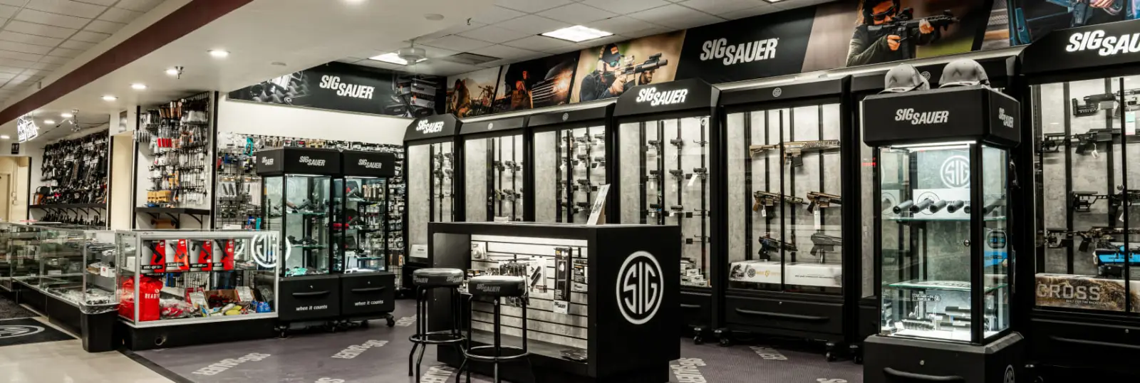 The Hub AZ Mesa showroom featuring glass display cases and firearms