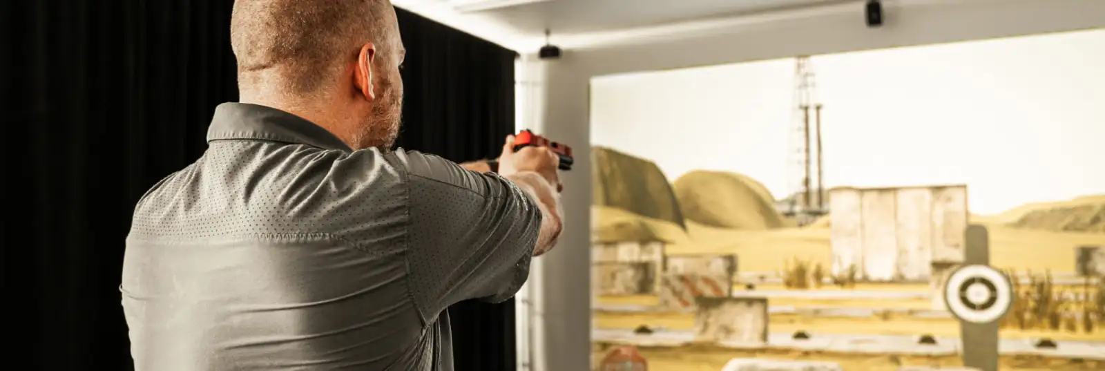 Customer practicing at The Hub AZ indoor shooting range with a paper target lane
